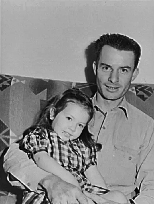 A man and his daughter pose for pictures at Camelback Farms in February 1942.