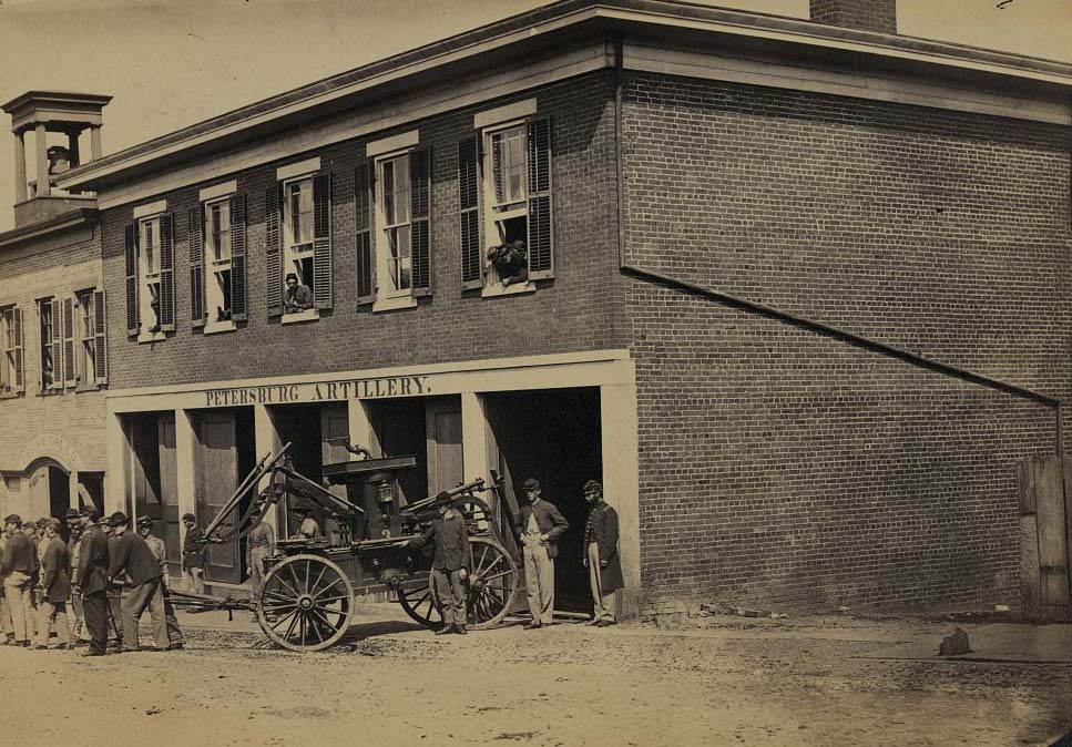 Union soldiers pull a fire engine from a garage designated Petersburg artillery, 1865
