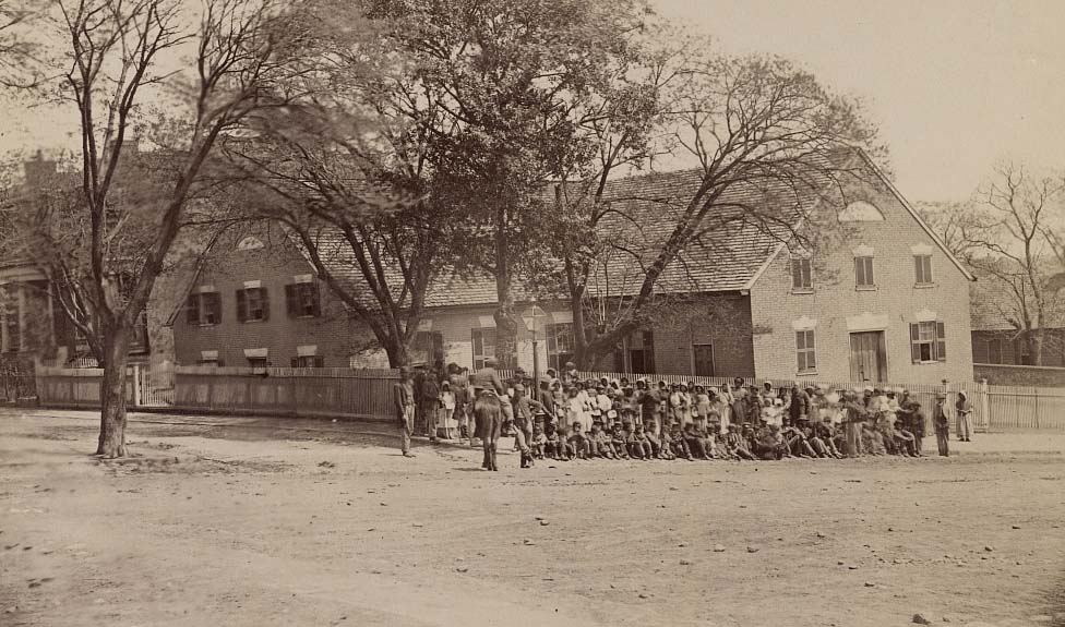 Group of African American men and women in front of the church on Broad Street in Richmond, 1864