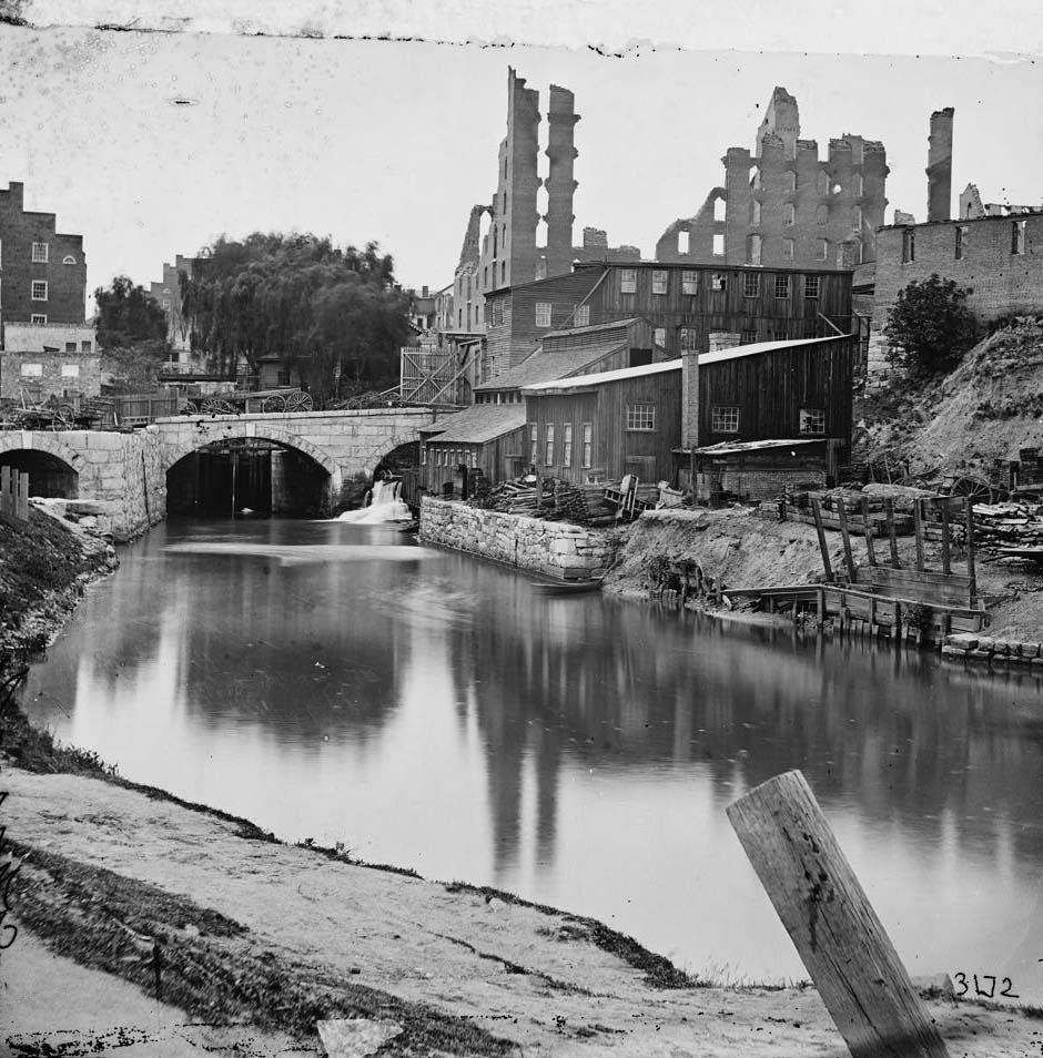 View on James River and Kanawha Canal near the Haxall Flour Mills; ruins of the Gallego Mills beyond, 1864