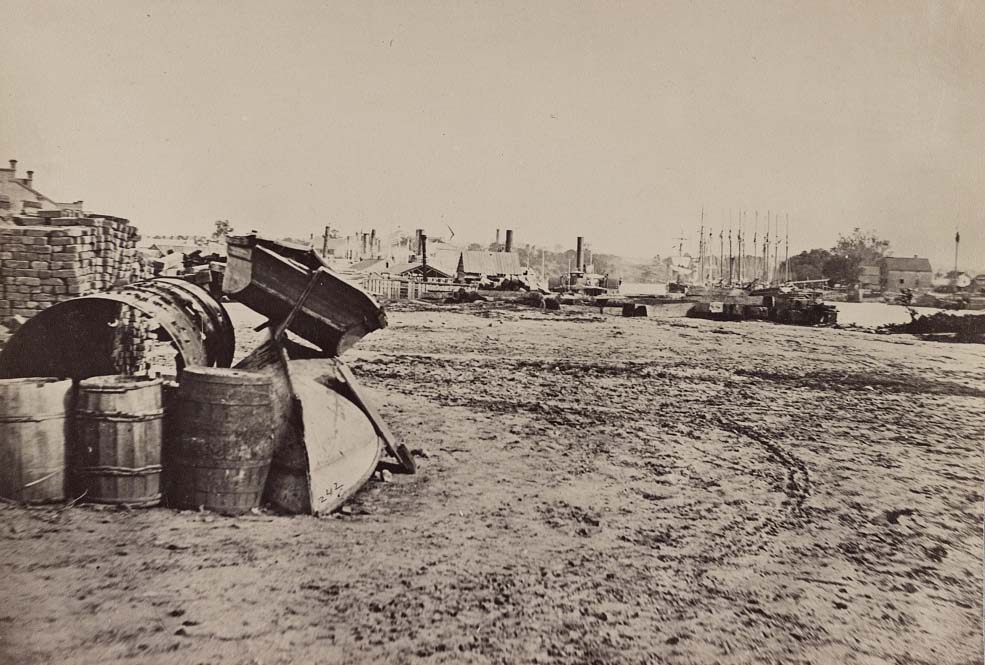 Barrels and dinghies on the dock at Rockett's Landing, 1865
