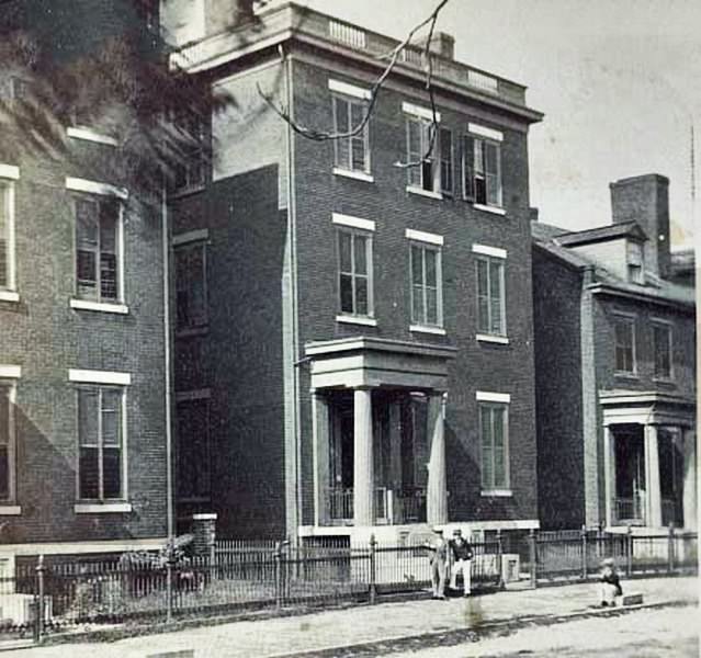 Three people in front of the home of General Robert E. Lee, at 707 E. Franklin Street in Richmond, Virginia, 1861