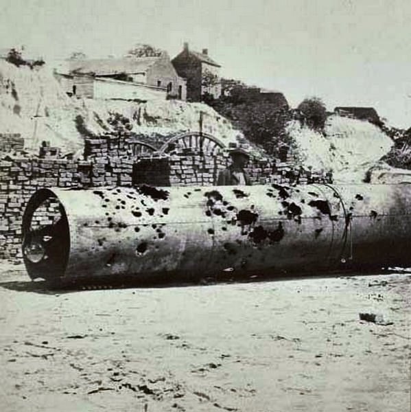 A damaged smokestack from the Confederate ram "Virginia No. 2" full of holes from Union gunshots, and further damaged by the Confederates before their evacuation of the city, 1864