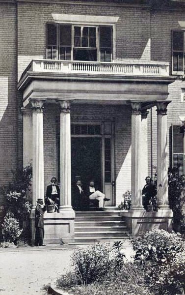 A group of men seated in the portico of the governor's mansion in Richmond, 1861