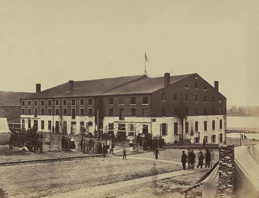A group of people gathered outside Libby Prison, an old tobacco warehouse and former Confederate military prison, now held by the Union Army, 1866