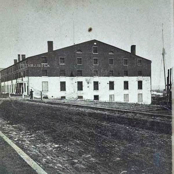 A man standing in front of Libby Prison, a Confederate facility in Richmond, Virginia, 1860