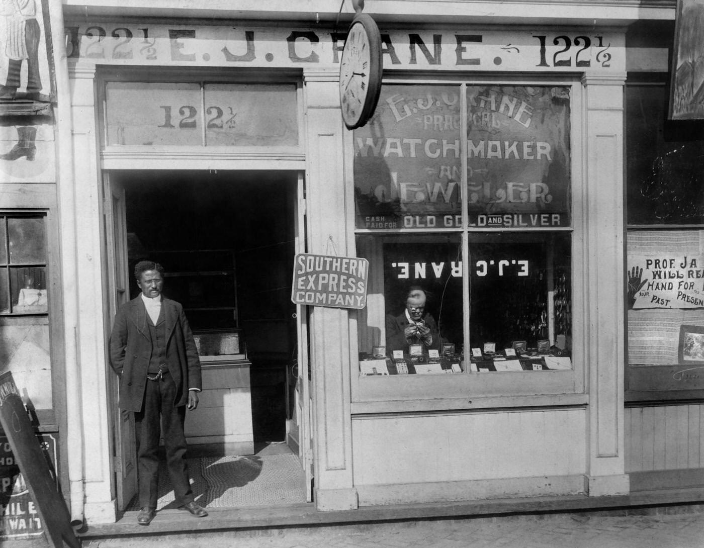 Man Working in Window and Man Standing in Doorway, EJ Crane Watchmaker and Jewelry Store, Richmond, Virginia, 1900