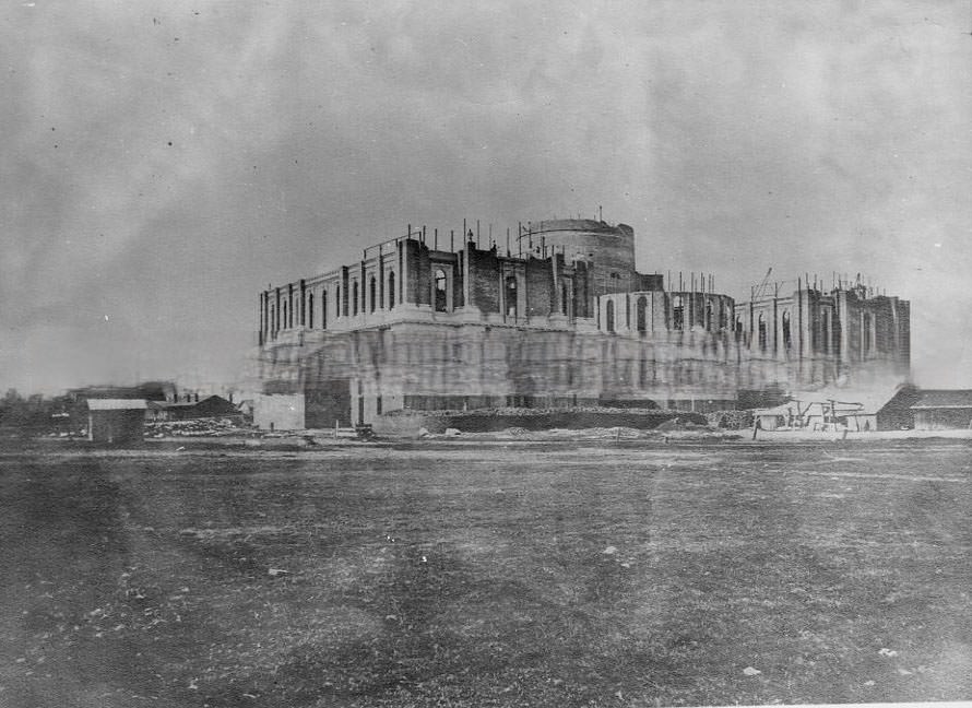 Exterior view of the state capitol during its construction. View taken from the southeast side of the building, 1869