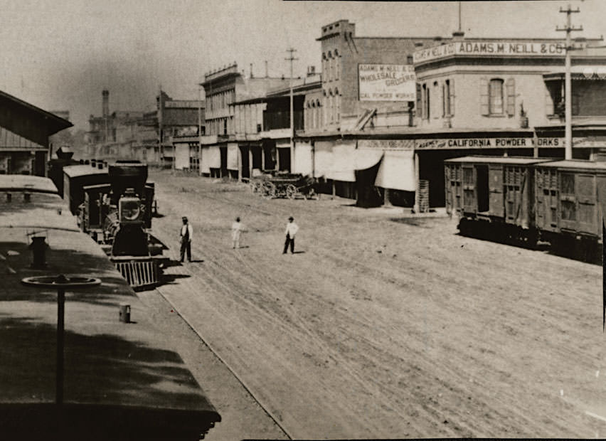 View looking north on Front Street from L Street; shows Central Pacific freight shed, 1869