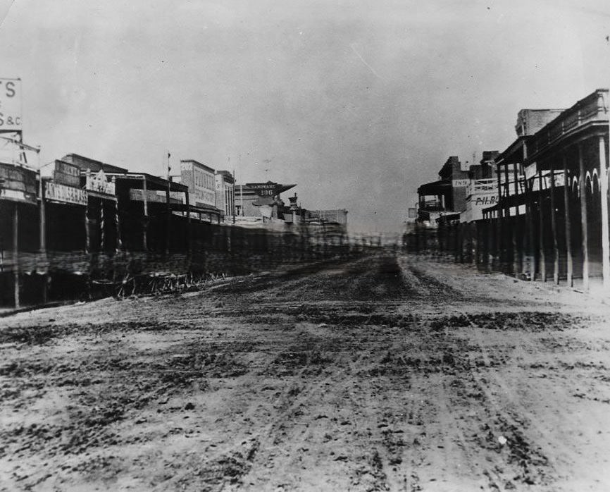 Street scene from 1868 looking west down J Street from 9th Street. Moore and Prentice Hardware is on the far left, 1868