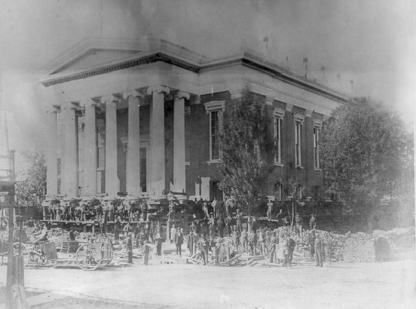 The second Sacramento County Courthouse being raised during the street raising project of the 1860s.