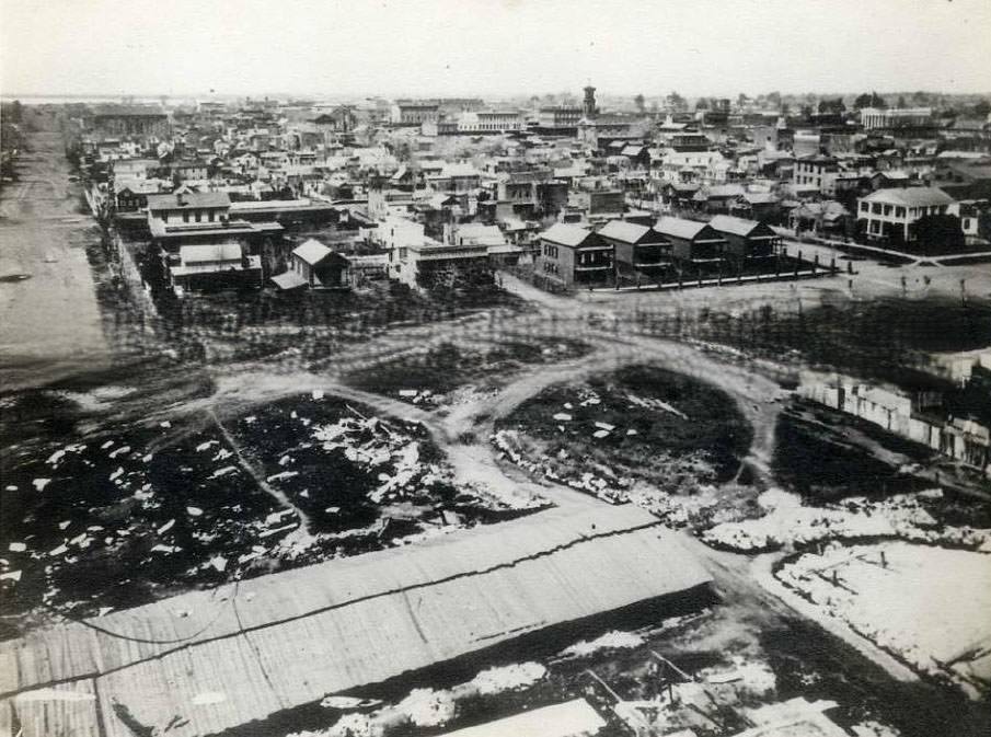 Cityscape of Sacramento taken from the state capitol building under construction. Taken from the Capitol Building. 10th street L to M street, looking West, 1868