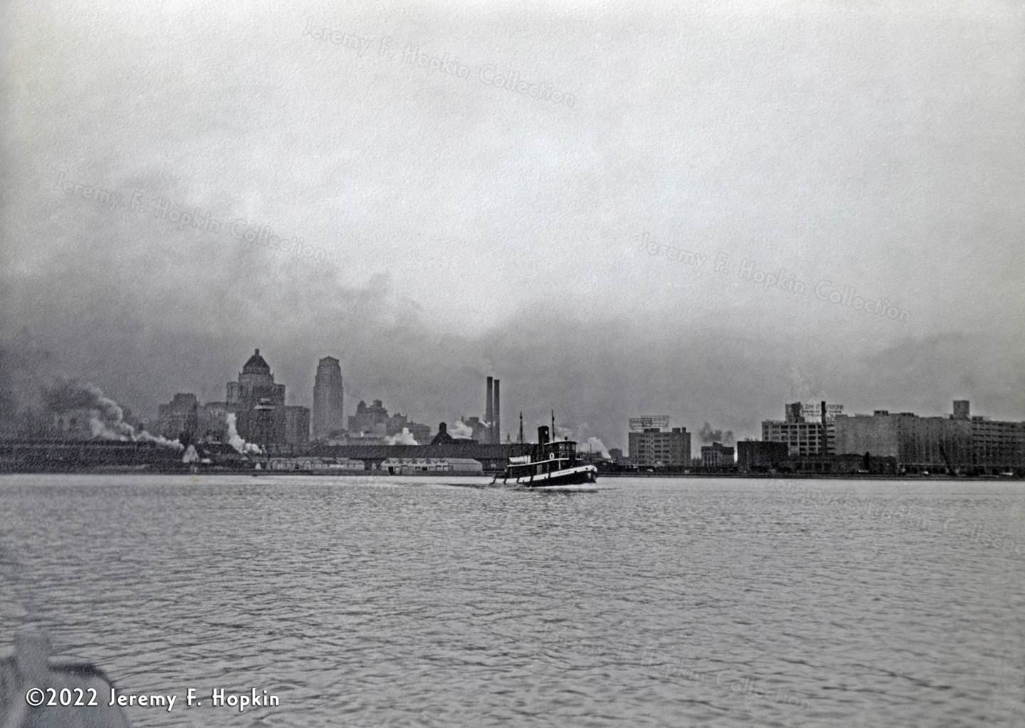 The tugboat 'Ned Hanlan' plies its way through Toronto's harbour, 1937.