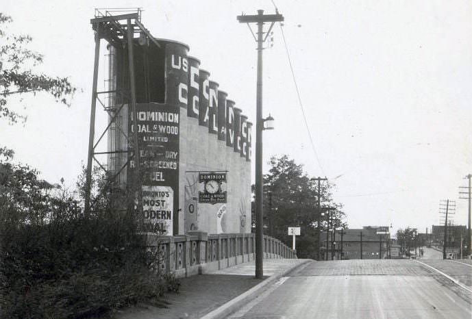 Dominion Coal & Wood Limited - Item is a photograph of signage painted on a set of silos located on Mount Pleasant Road, at Merton Street, 1934