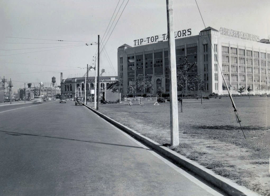 Tip-Top Tailors building, Lake Shore Road at Stadium Road. Maple Leaf Stadium is visible in the background. View is looking east, 1935