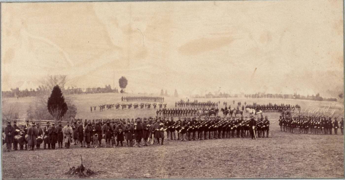 A military band leads the assembled companies of the 2nd Rhode Island Infantry, Washington, D.C., 1865