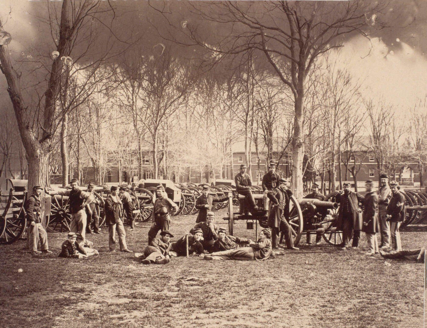 Federal soldiers pose on and around a display of cannons at the Washington Arsenal, Washington, D.C., 1861