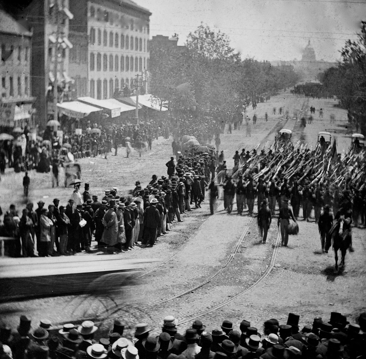Infantry unit with fixed bayonets followed by ambulances passing on Pennsylvania Avenue near the Treasury, during the "grand review" of the Union Army, Washington, D.C., 1865