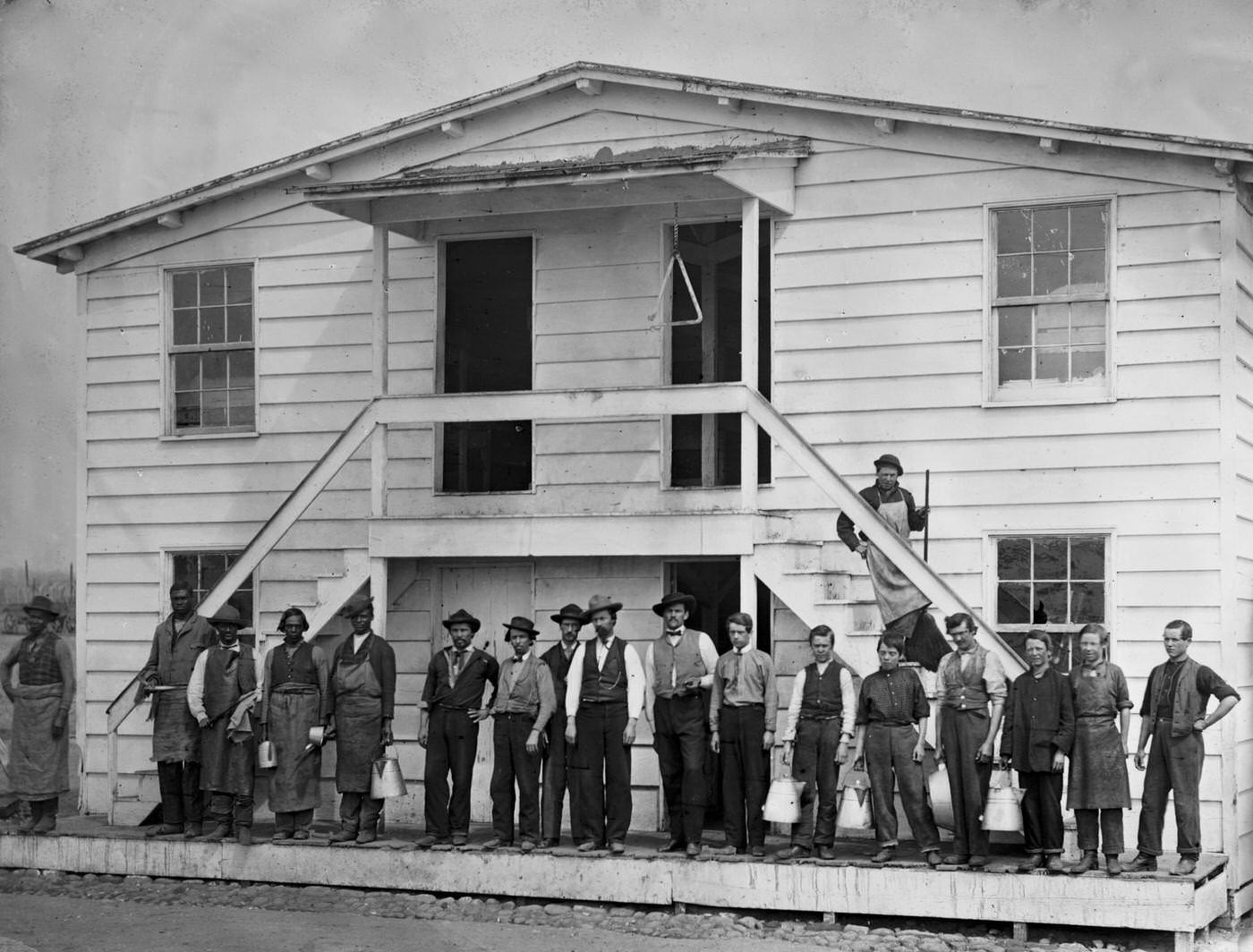 Men standing in front of the mess house at the government stables, Washington, D.C., 1865