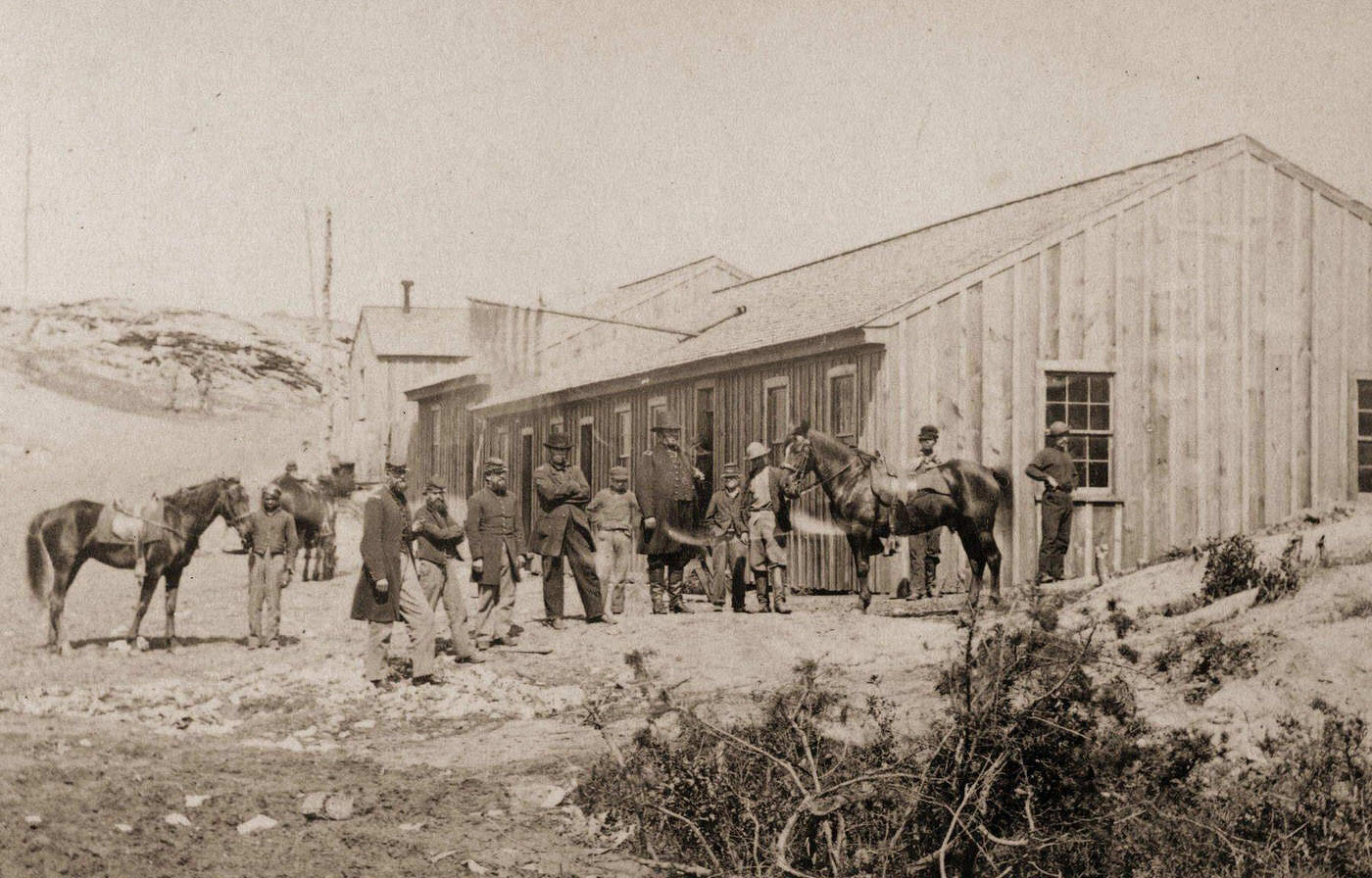A Civil War scene featuring a view of a Confederate Quartermasters House with a group of officers meeting outside, Washington DC, 1863.