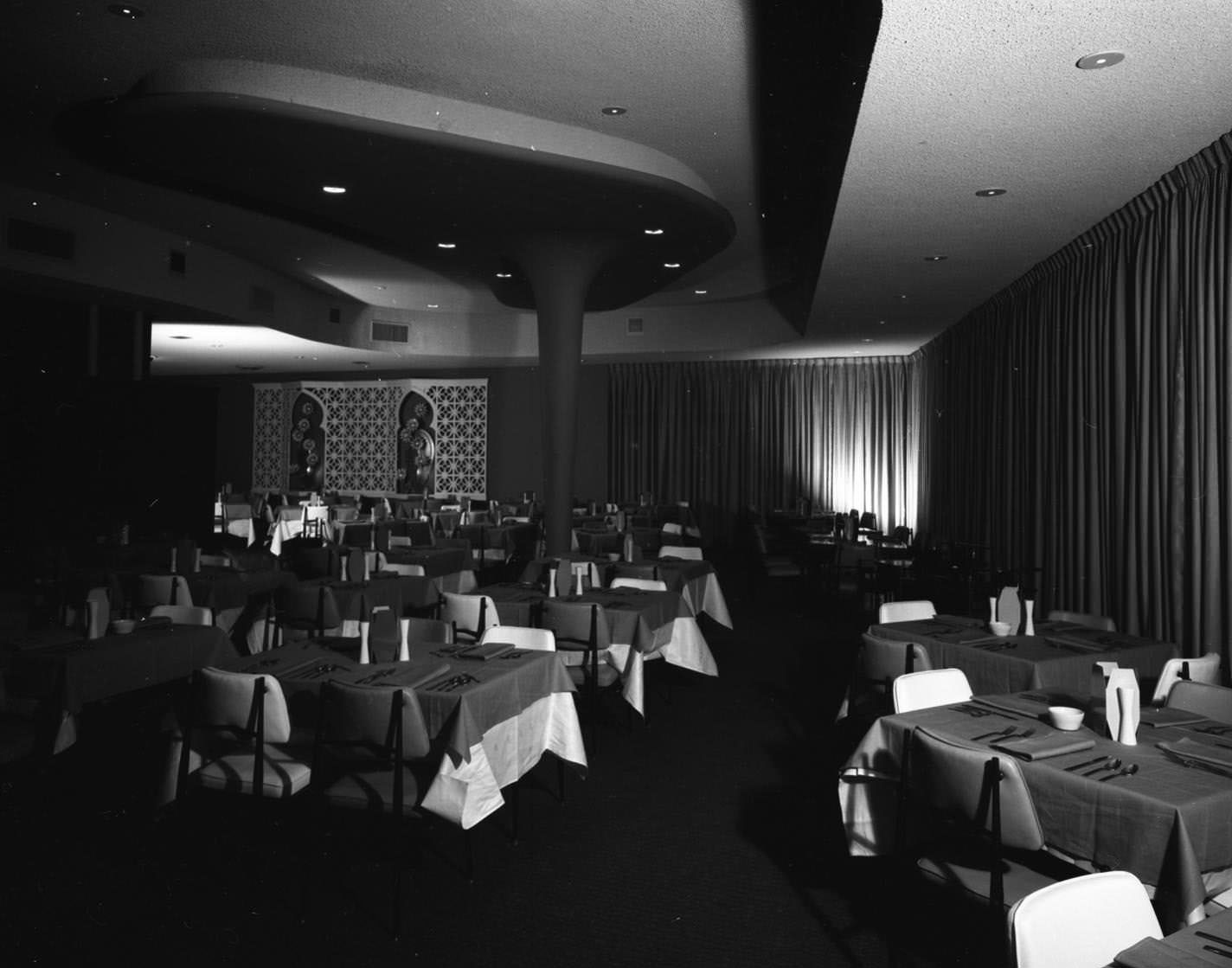 The Paradise Room restaurant with most tables set for a group of four, 1957