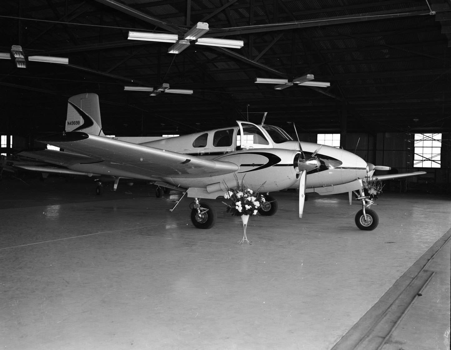 A Beechcraft Model 50 Twin Bonanza inside a hanger at the Jack Hughes Airport in Abilene, Texas, 1956