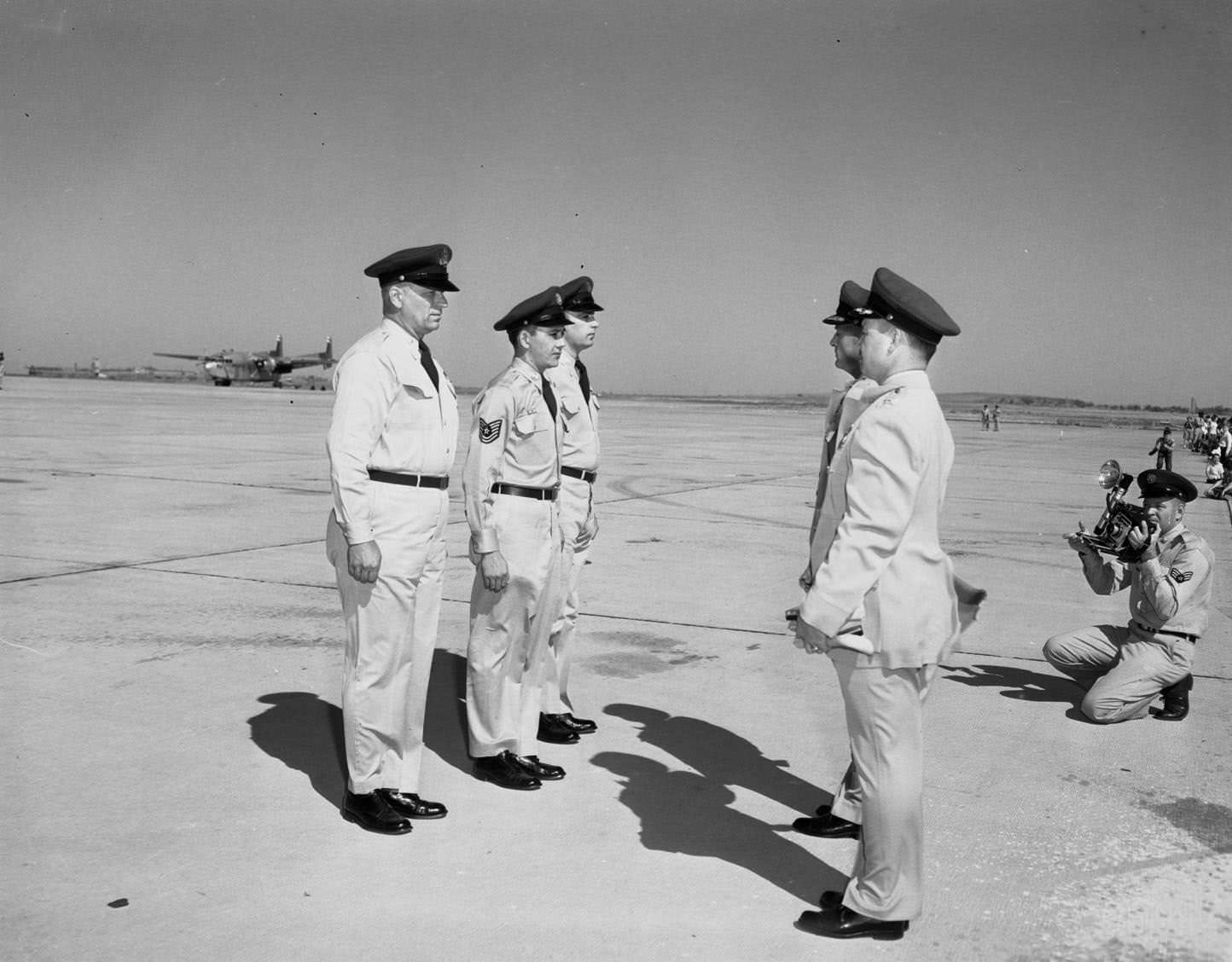 Five Air Force personnel standing on a runway at the Dyess Air Show in Abilene, Texas, 1955