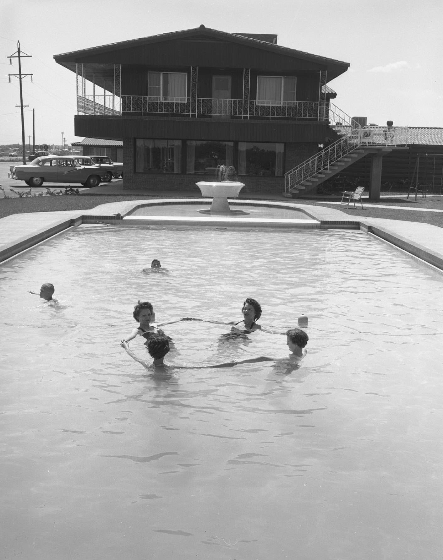 A group of people in the Thunderbird Lodge Hotel swimming pool, 1950s