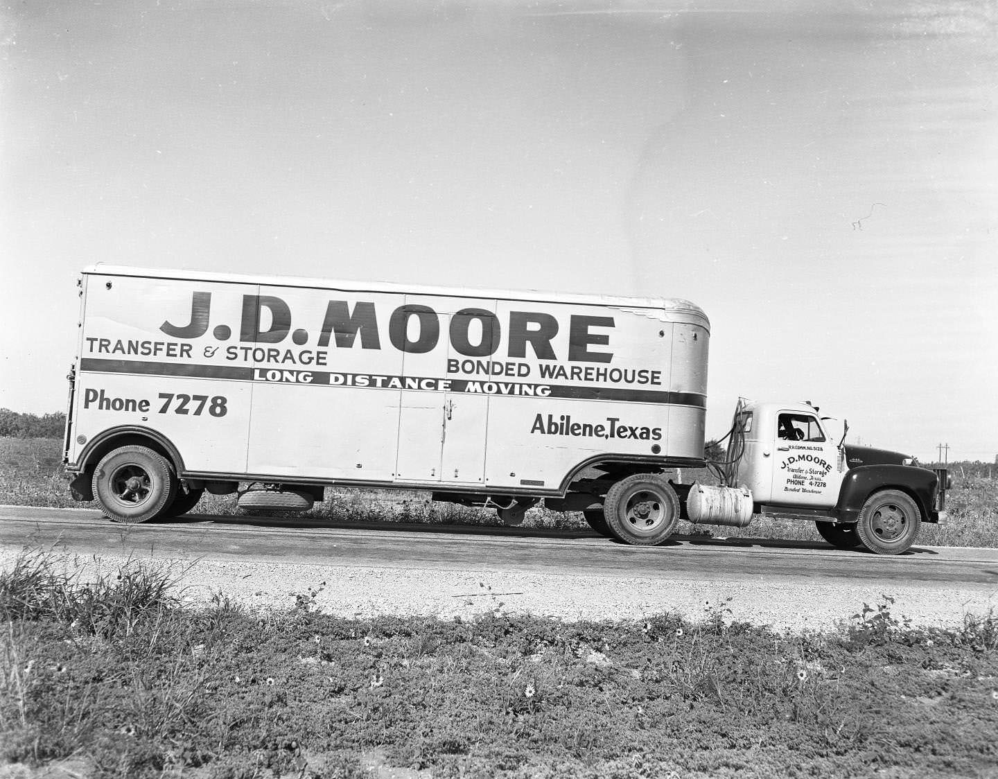 A J. D. Moore moving truck on the side of the road, 1958