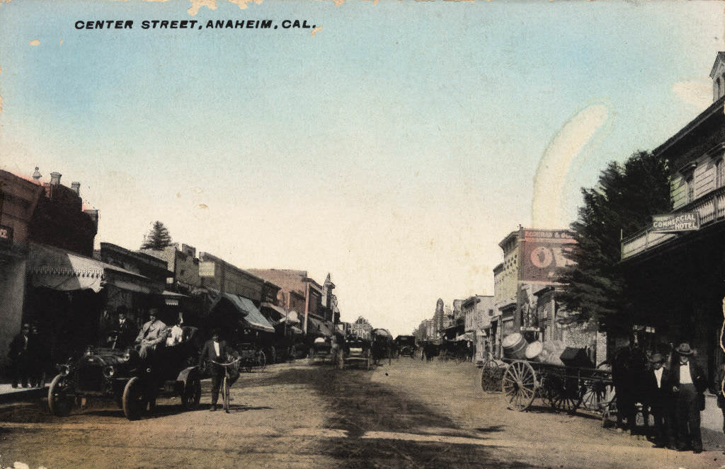 View looking down Center Street (now Lincoln Ave.), with both horse-drawn vehicles and early automobiles visible on the dirt road, 1892