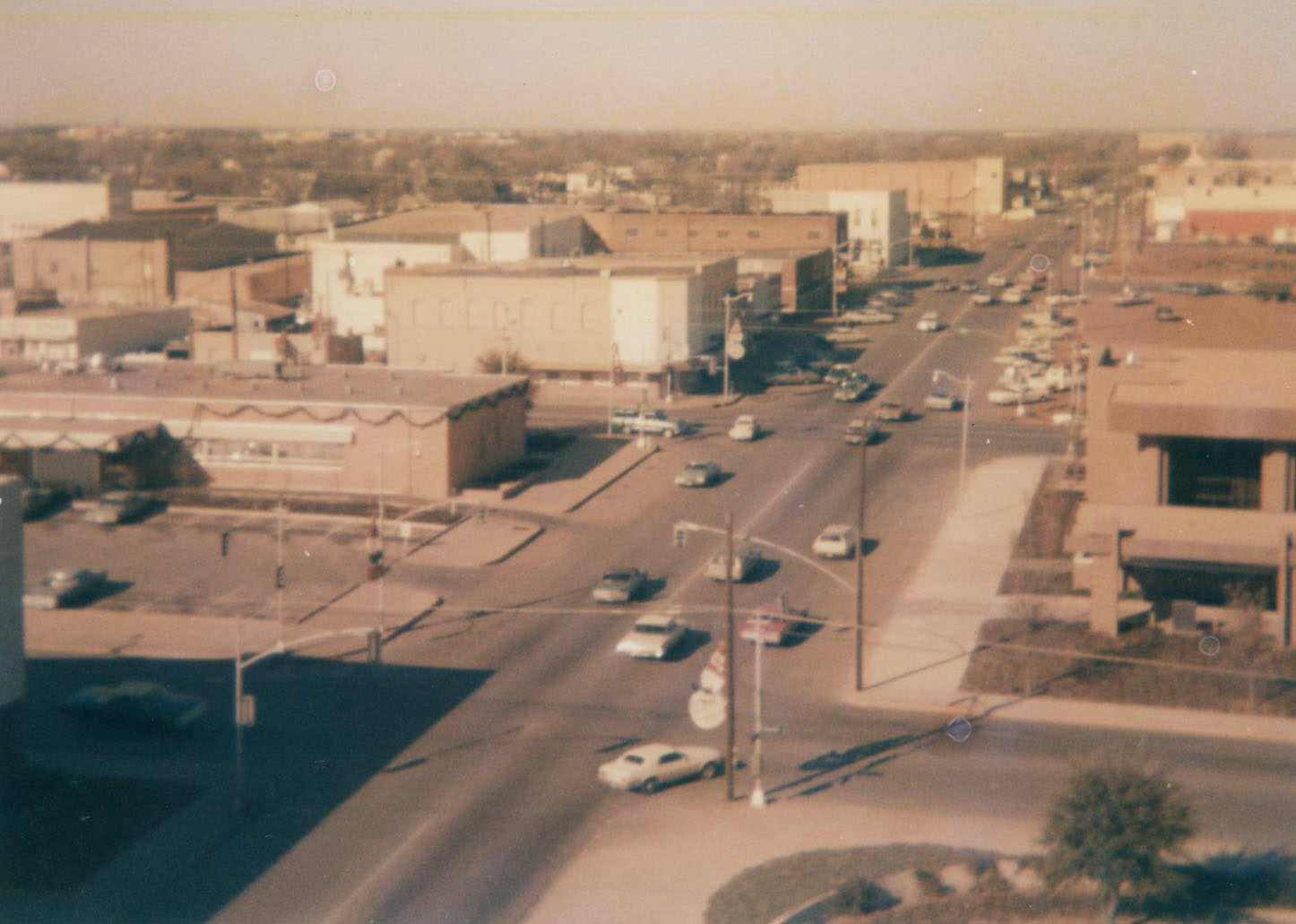 Downtown Arlington with buildings, cars, streets, and power lines, 1973