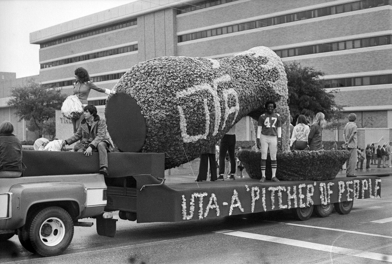 University of Texas at Arlington's homecoming parade, featuring a float with a design for "UTA - A 'Pitcher' of People" to reflect the diversity of people at the school.