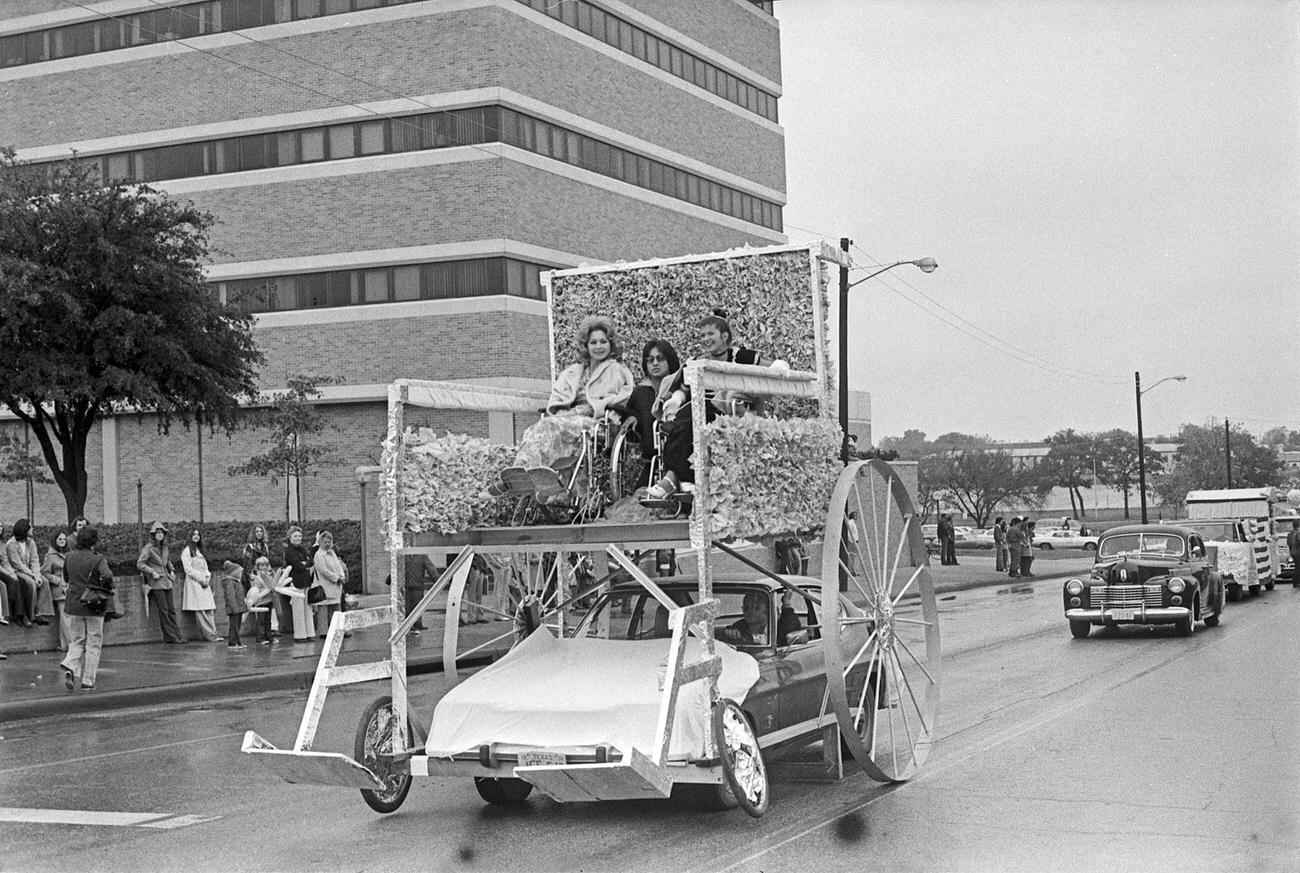 University of Texas at Arlington's Handicapped Student Association homecoming parade float. The parade was travelling northbound along Cooper Street in Arlington.