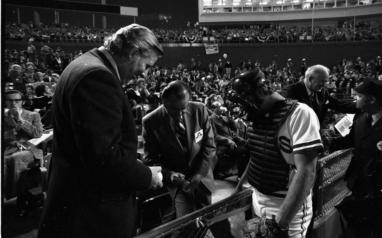 Texas Rangers opening night at Arlington Stadium; Texas Ranger owner Bob Short and Arlington Mayor Tom Vandergriff signing autographs, 1972