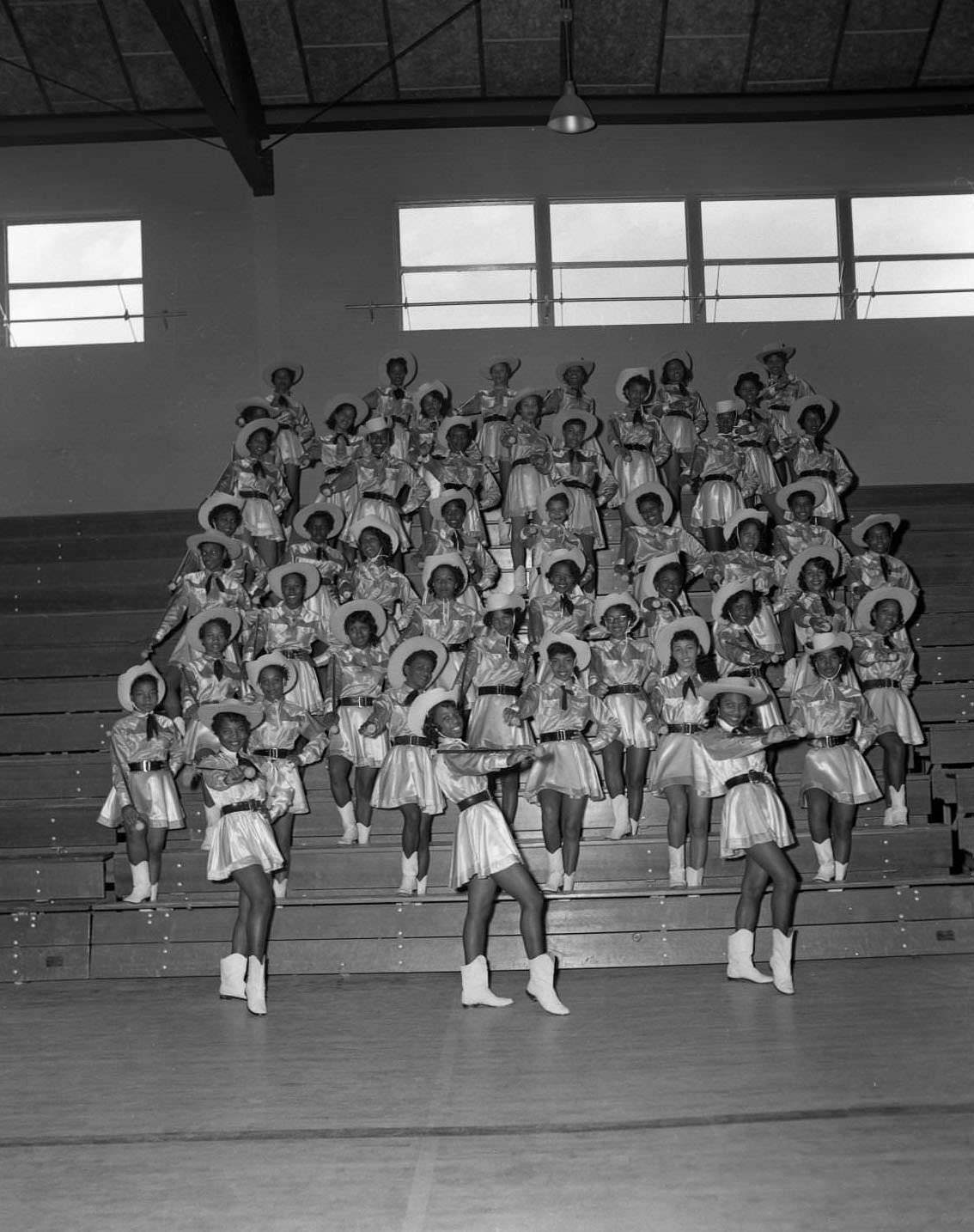 Anderson High School cheerleaders posing on school bleachers, 1955