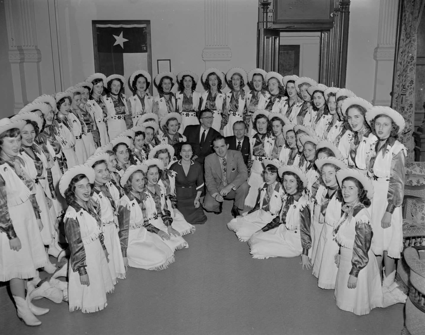 The Beaumont Melody Girls posing around three men and a woman, 1953