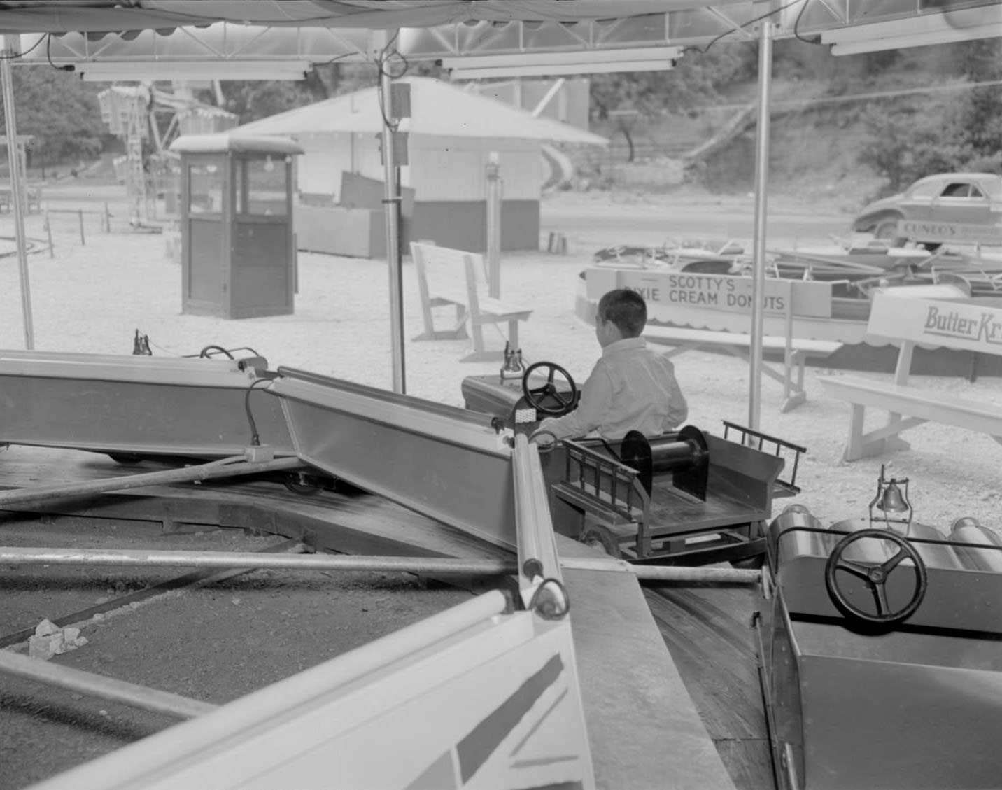 Boy riding on amusement park ride, Austin, 1950