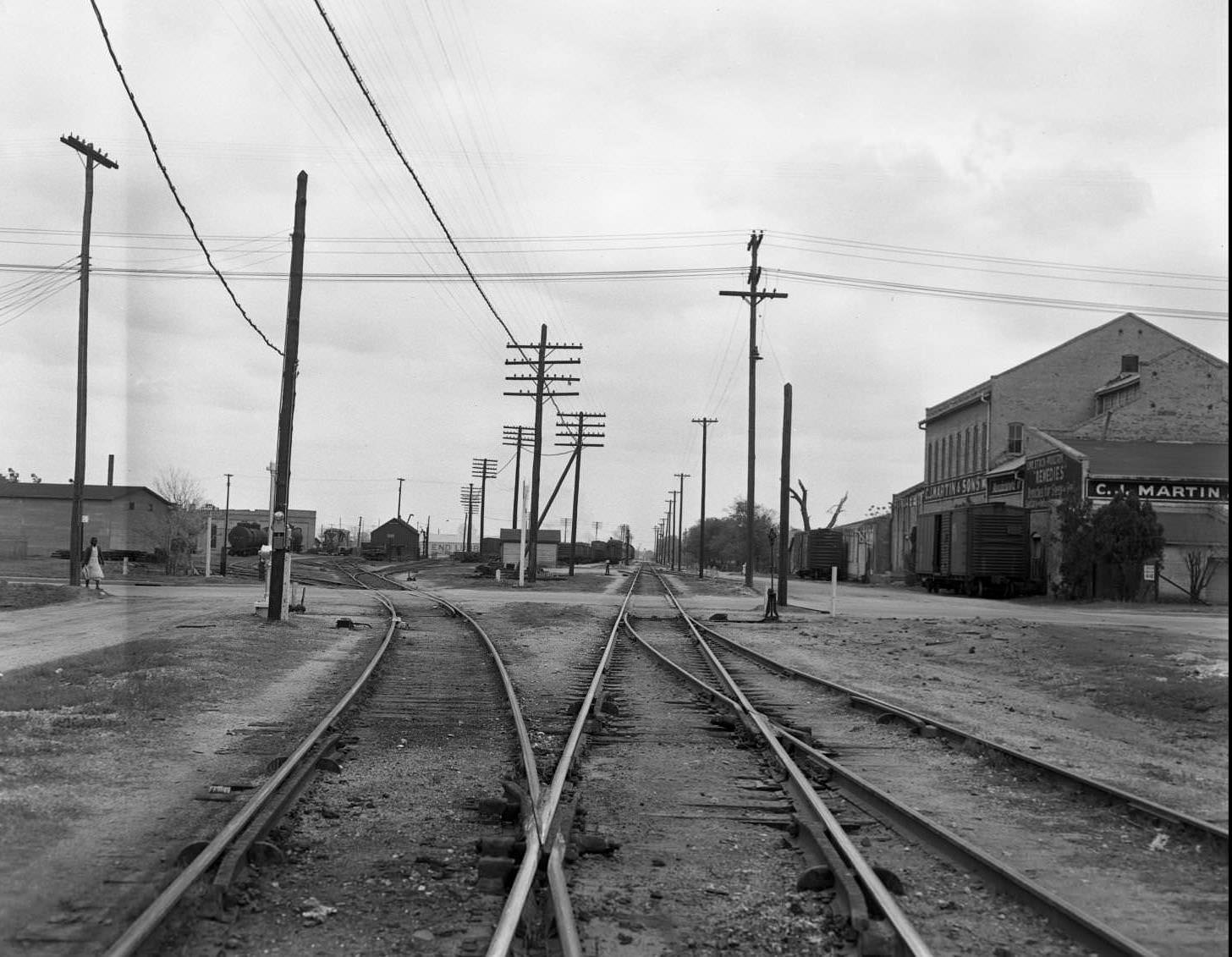 Looking East from the 1700 block of E. 5th at the railroad tracks at Chicon. C. J. Martin & Sons on the right, 1951