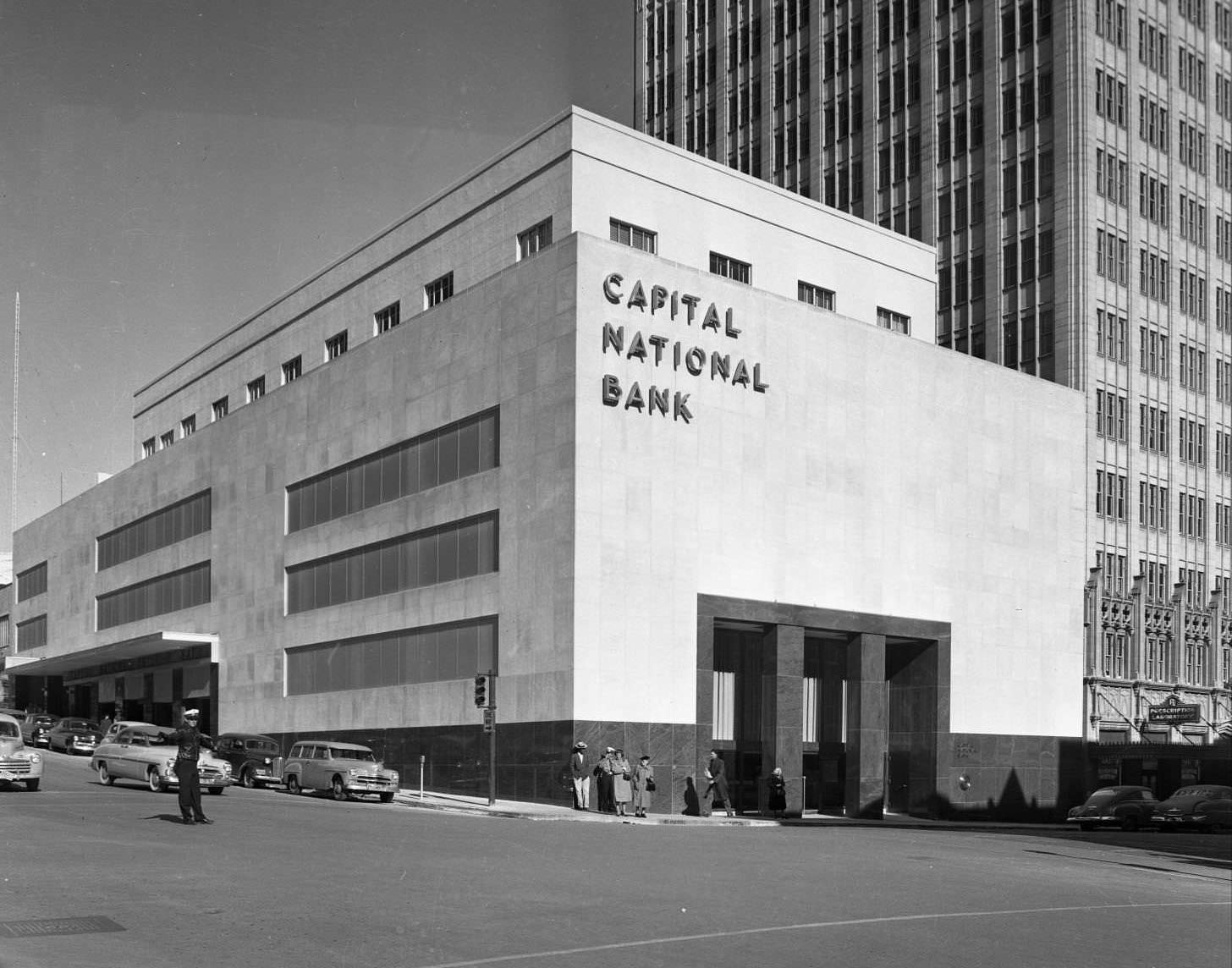 Looking northeast at the building at 114-120 W. 7th St from the intersection of 7th and Colorado St, 1951