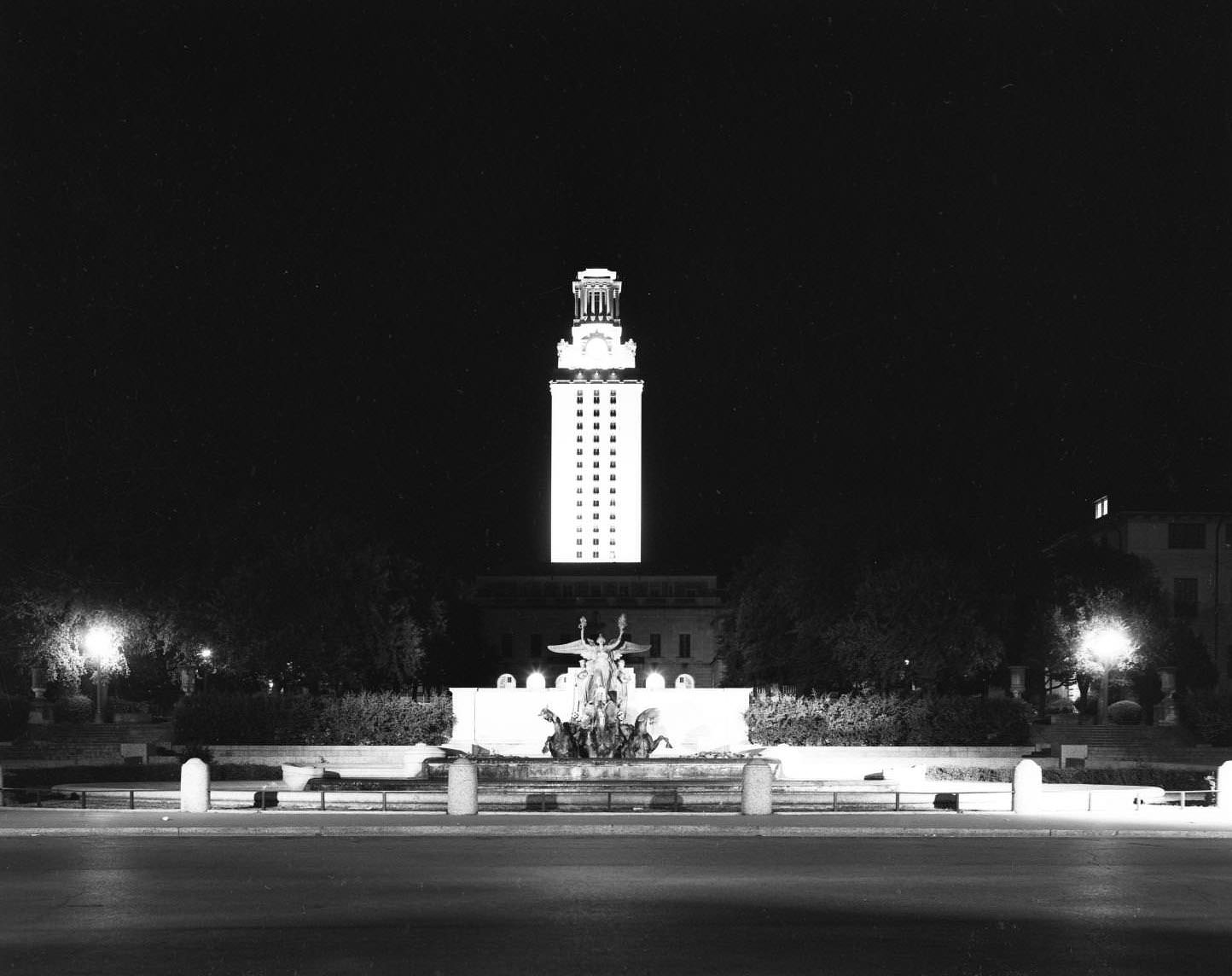Stark shot of the UT Tower lit up at night on 21st street, 1957