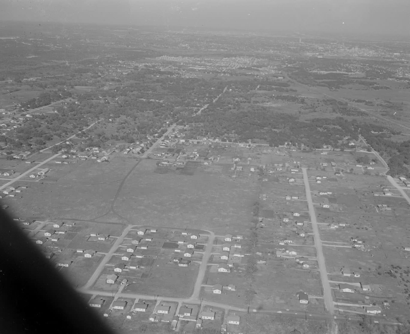 Aerial view of Austin with the Tower and Capitol barely visible in the background, 1953