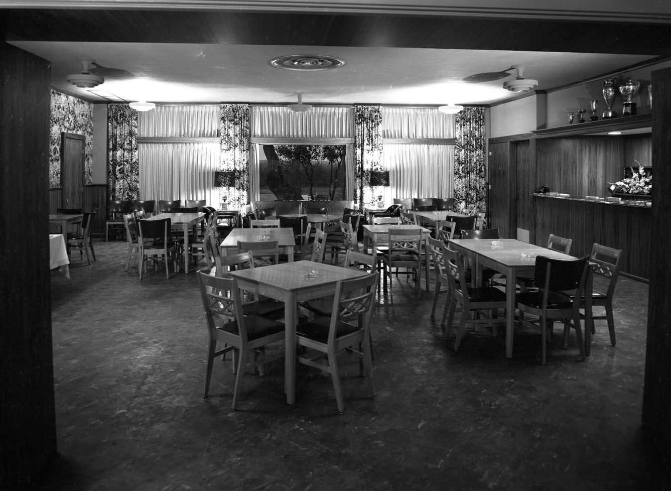 Interior view of room with tables and chairs. The County Club was on Montopolis Rd. (Riverside Drive), 1950