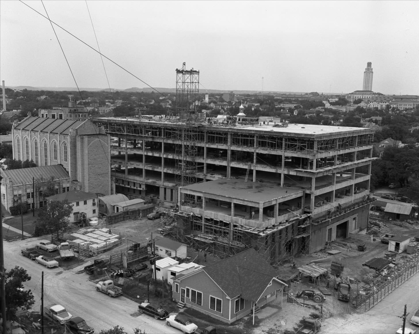 Aerial shot of steel frame structure of TEC building. Brazos St is on the lower right and 14th on the lower left, 1958