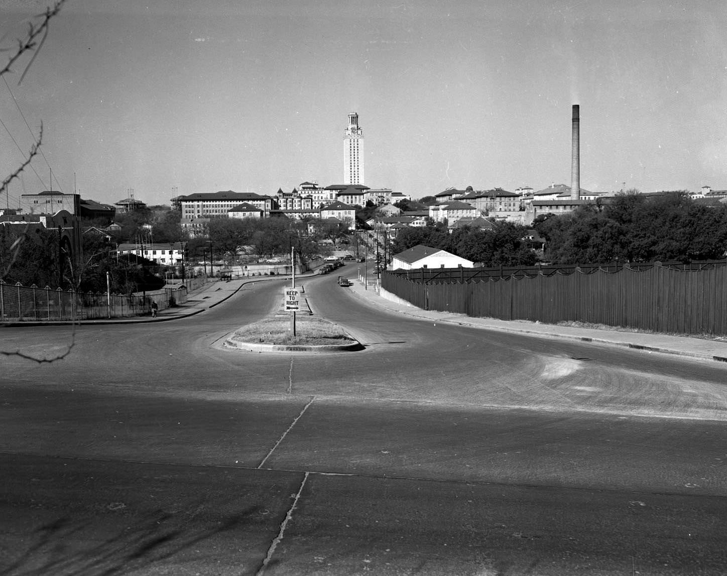 View of construction fencing to the north of the intersection of E. Campus Dr. and 23rd Street, 1951