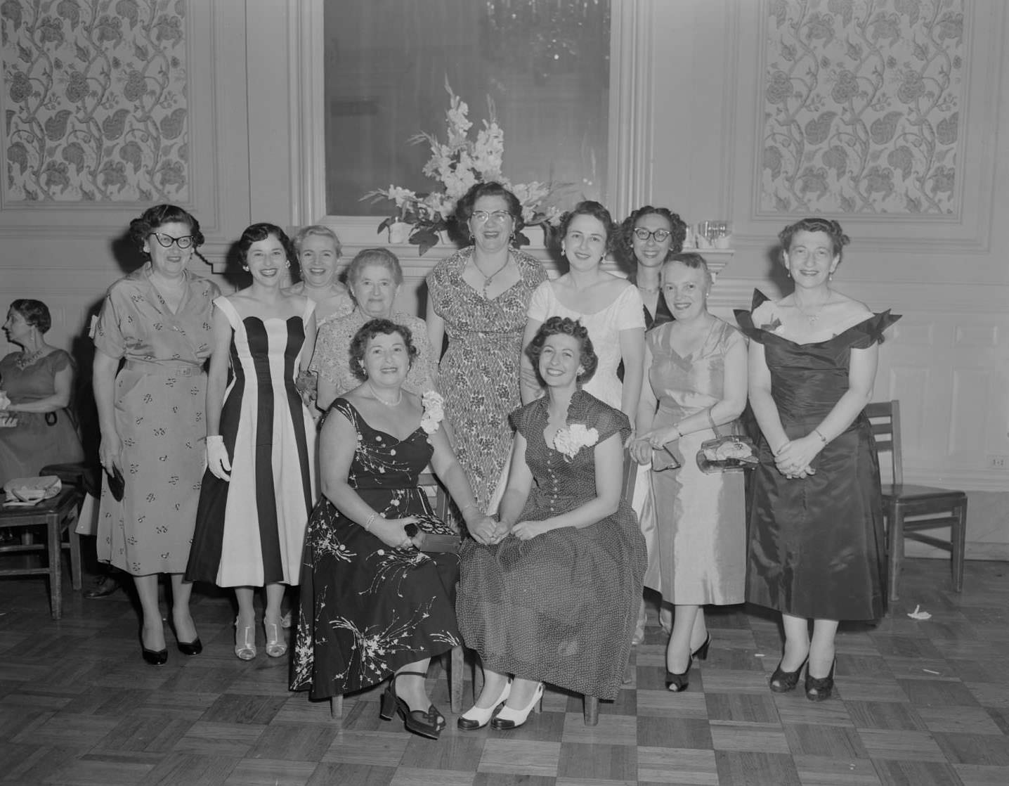 A group of women from the Austin Chapter of Hadassah posing for a photo at a formal gathering, 1954