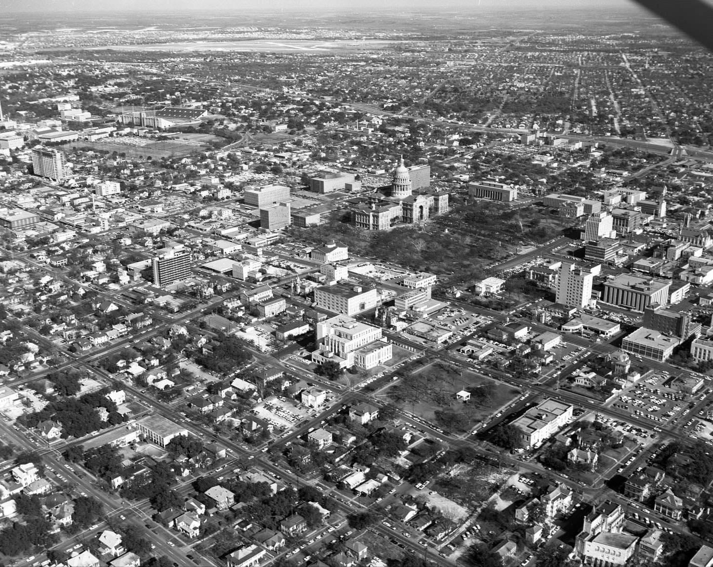 Aerial shot of Downtown Austin, State Capitol, and in particular the Lowich Building, 314 W 11th St., 1965