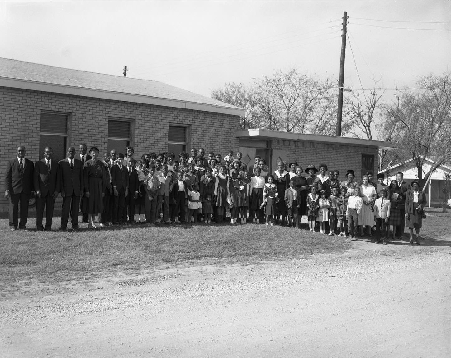 Entire congregation of the Seventh Day Adventists pose together outside church, 1965