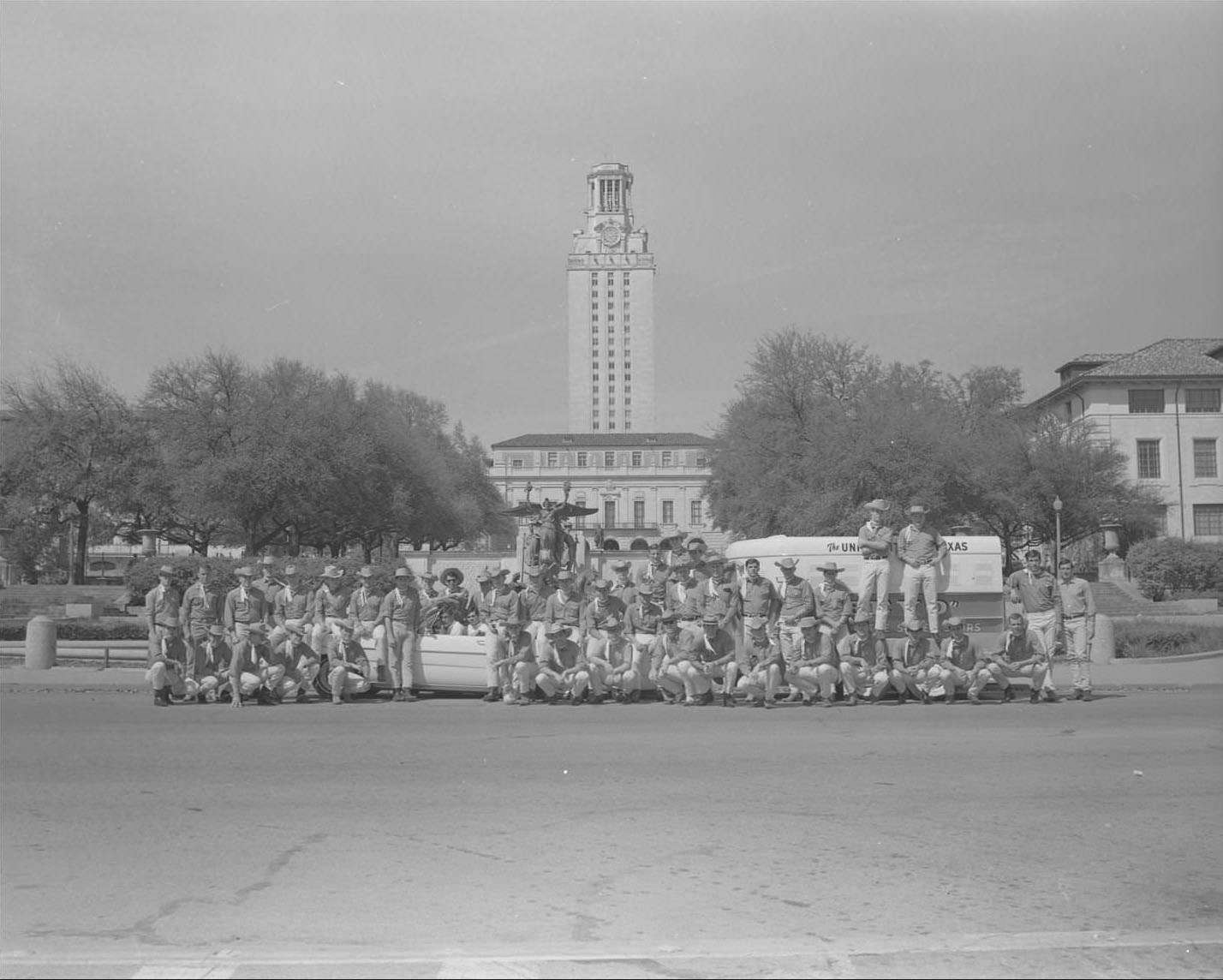 UT Silver Spurs group poses in front of Littlefield Fountain and UT Tower, 1965