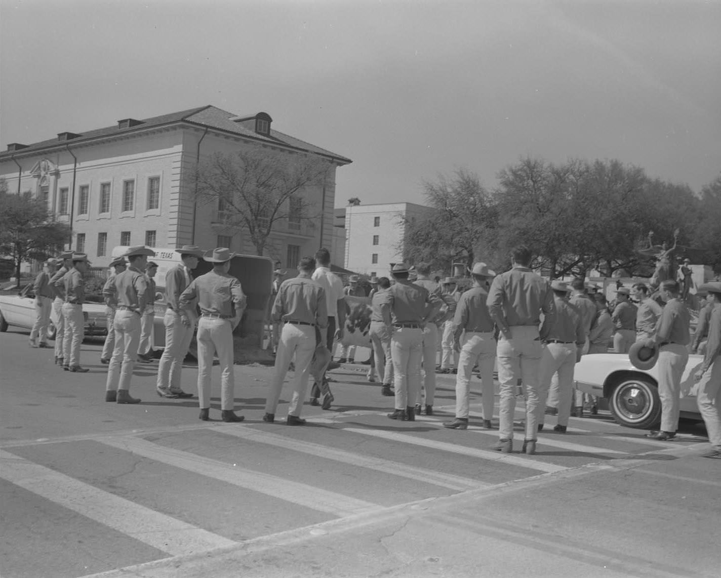 UT Silver Spurs stand facing the Littlefield Fountain and UT Tower on 21st Street at the UT campus, 1965