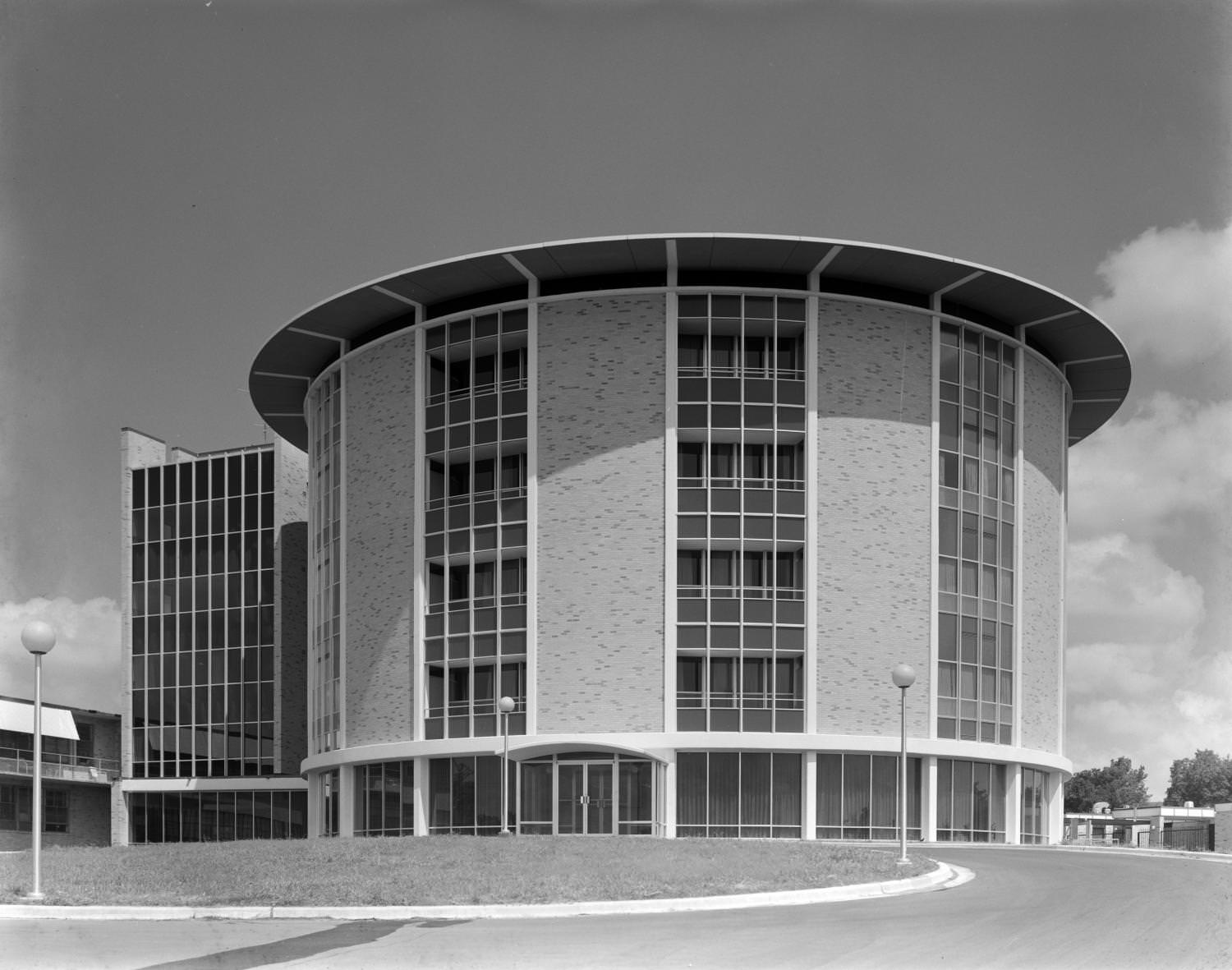 A round five-story building of a modern, postwar design, 1965